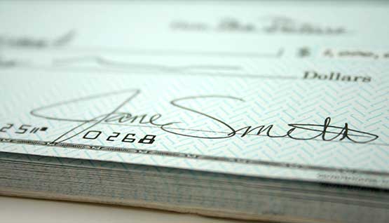 A close-up crop of a signed check.