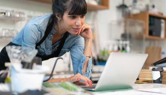 A cafe owner looks over her transaction history for the day.