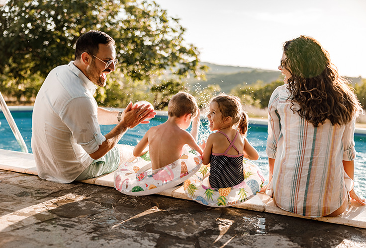 family-playing-by-pool