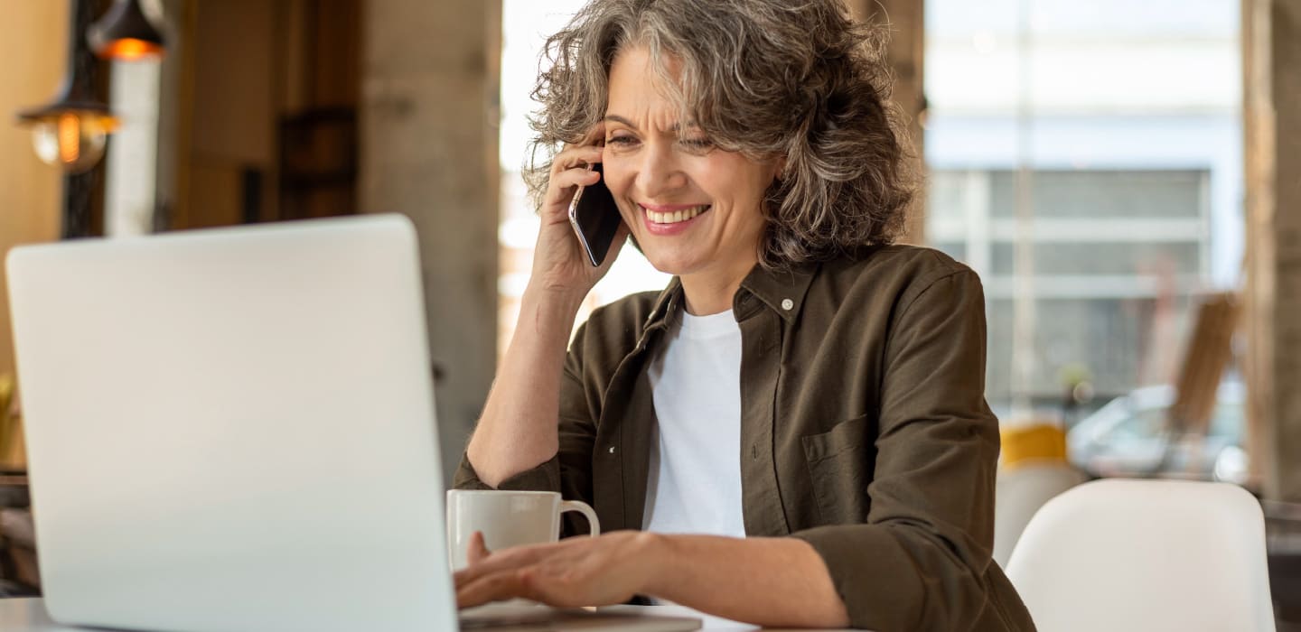 confident woman in her fifties looking at her laptop